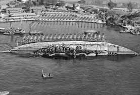 29 March 1943, USS Oklahoma's parbuckle salvage. Ship rotated 90 degrees.