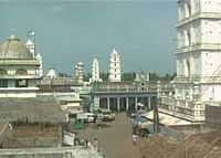 a view of street with minaret in the background