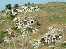 Rock caves on a hillside.