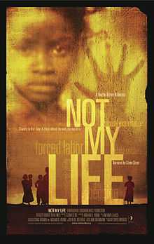 The words "NOT MY  LIFE" in light yellow superimposed on a darker yellow background with the face of a child peering over the words