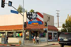 A building with a painted caricature of Barack Obama in Superman's clothes in its facade.