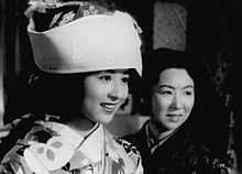 An image of Kyoko Kagawa in a fancy traditional dress, next to another woman.