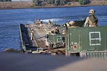 Marines crossing ribbon bridge