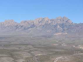 An aerial photo of the Organ Mountains from the west
