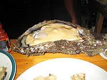 A 2-ft-long open oyster on plate
