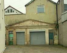 Yellow stone building with metal shutters