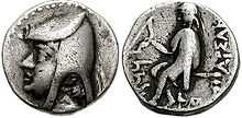 Two sides of a silver coin. The one on the left bears the imprint of a man's head, while the one on the right a sitting individual.