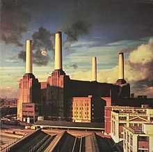 Picture of factories with tall chimneys pouring out black smoke.