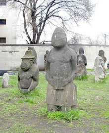 Large rude stone statues depicting men and women