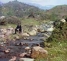 Prokudin-Gorsky sitting by a stream