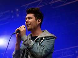 Lead vocalist Dan Smith holding a microphone