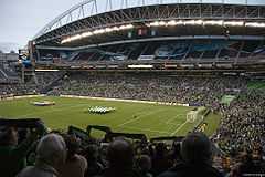 A view of a soccer field from high in the crowd before a match.