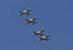 Four monoplane aircraft flying in close formation. The aircraft are painted grey and have been photographed from below.