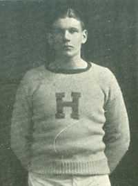 Ralph Gorman Hills, posing against a dark background while wearing his Hill School sports uniform with a prominent letter "H" on the chest