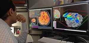 researcher looking at fMRI test