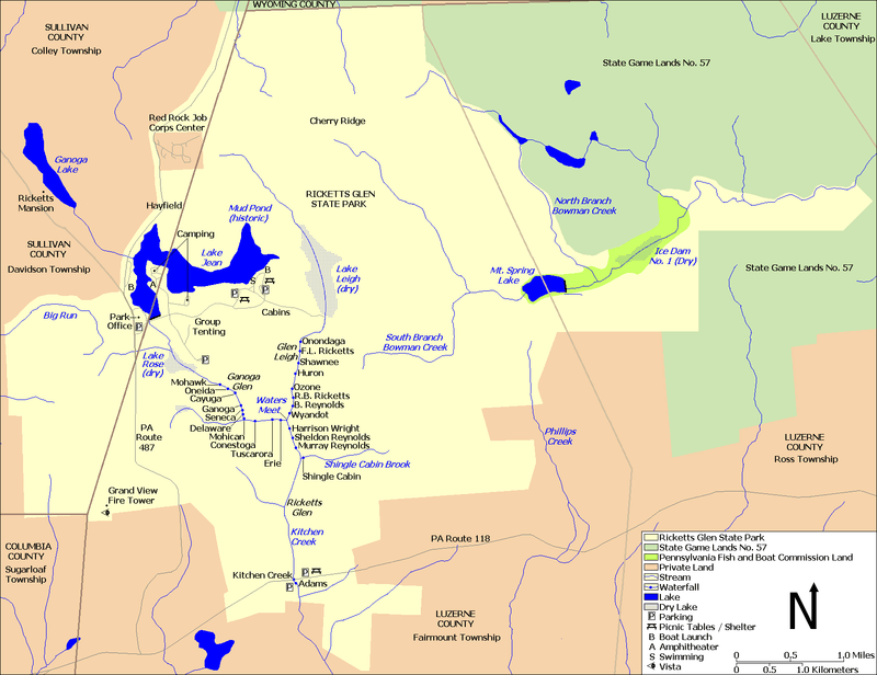 A map showing Kitchen Creek flowing southeast from Ganoga Lake, through Lake Jean, and then through the dry bed of Lake Rose into Ganoga Glen with ten waterfalls. A second branch of the creek flows south through the dry bed of Lake Leigh, then through Glen Leigh and its eight waterfalls. These branches meet at Waters Meet and the creek flows south through Ricketts Glen and its six waterfalls. The South Branch Bowman Creek is east of Lake Leigh and Big Run is west of Lake Rose. Pennsylvania Route 487 runs north-south at left, and Pennsylvania Route 118 runs east-west at the bottom of the map. County borders are also shown.