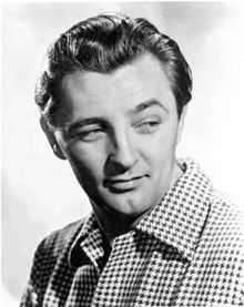 Black and white promotional headshot of Robert Mitchum facing right and looking left