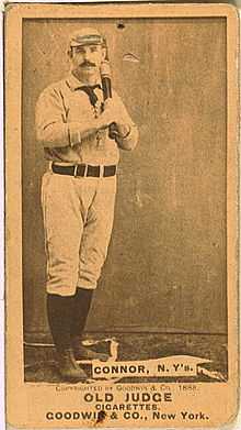 Baseball card of a man in a baseball uniform, dark socks, and shoes holding a baseball bat against his chest. Text on the bottom reads "CONNOR, N.Y's." Below this reads "Copyrighted by GOODWIN & CO., 1888". Below this is "OLD JUDGE CIGARETTES. GOODWIN & CO., New York."