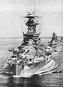 Royal Oak sailing in line astern ahead of two other battleships. R O is painted in very large letters on the top of her B turret.