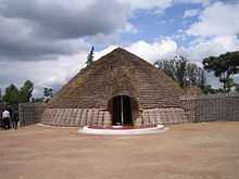 Photograph of King's palace in Nyanza, Rwanda depicting main entrance, front and conical roof