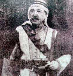 Grainy photo of mustachioed man in traditional Syrian dress