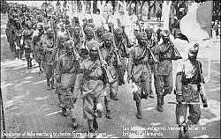 Postcard of marching Sikhs with rifles
