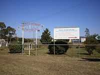 Landscaped Sister Kenny memorial, with signs and turnstile