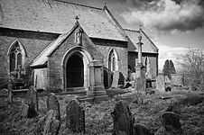 View of church porch with gravestones on the foreground