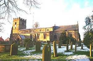A long church with a battlemented west tower
