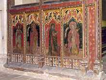 The lower part of a brightly painted screen showing four figures
