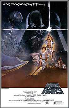 Film poster showing Luke Skywalker triumphantly holding a lightsaber in the air, Princess Leia sitting beside him, and R2-D2 and C3PO staring at them. A figure of the head of Darth Vader and the Death Star with several starships heading towards it are shown in the background. Atop the image is the text "A long time ago in a galaxy far, far away..." Below is shown the film's logo, above the credits and the production details.