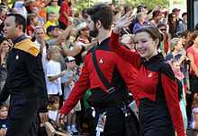 People wearing Star Trek: the Next Gneration uniforms in a parade.