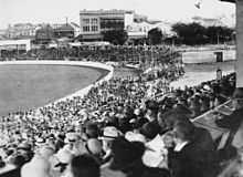 A crowd watching a cricket match