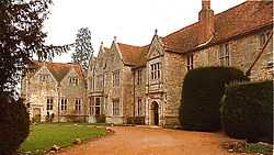 Long, two-story light-brown stone building