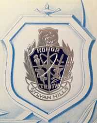 Sylvan Hills High School crest depicting the words 'Honor' and 'Truth' with a Bear atop the crest.