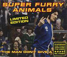 A dark-haired man in blue, white and yellow football kit scowls as he turns to his left, holding the index and middle fingers up on his right hand, his palm facing inwards. The hand points to an out-of-image figure, but appears to be pointing to the viewer. "Super Furry Animals" is rendered in yellow and red text across the top, while along the bottom the single's title is partially given: "The Man Don't Give a ****". The final word is obscured by a sticker, which itself claims that the word is used 50 times during the song