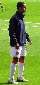  A man in a football uniform, warming up before a football match