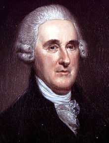 Upper body of a well-dressed man with a large forehead wearing a powdered wig