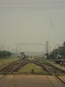 a x-shaped interception of railroads with a repair crew carrying out maintenance