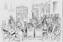 men at table in military uniforms, others standing