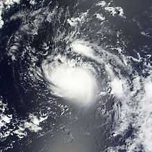 A satellite imagery of a swirling mass of clouds over the open Atlantic.