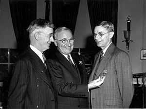 Three smiling men in suits