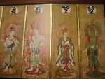 Four deities on four sections of a folding screen. Two of them are female and dressed in robes. The other two are male and only sparely dressed. All four have halos with flames.