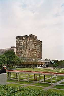 Tall square-shaped building decorated on the outside with murals.