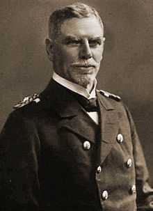 A older man in a double-breasted naval uniform