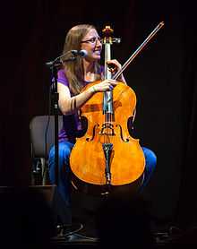 Photograph of Aubrey playing a cello.