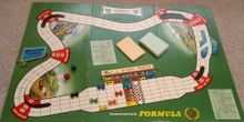 The start of a game of Waddington's Formula 1 showing board, playing pieces, card packs and dice.