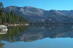 Photo of Warm Lake and surrounding forest and mountains during fall