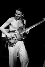 Pastorius, shirtless, playing bass in his early years.