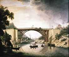 A painting of the bridge, from mid-river, in the picturesque style of the period. Smoking furnaces can be seen in the distance and a Severn trow is alongside the bridge. Two wealthy coaches are visible, as are a well-dressed party of sightseers in a small boat. The bridge is rust-red in colour, suggesting that it was unpainted.